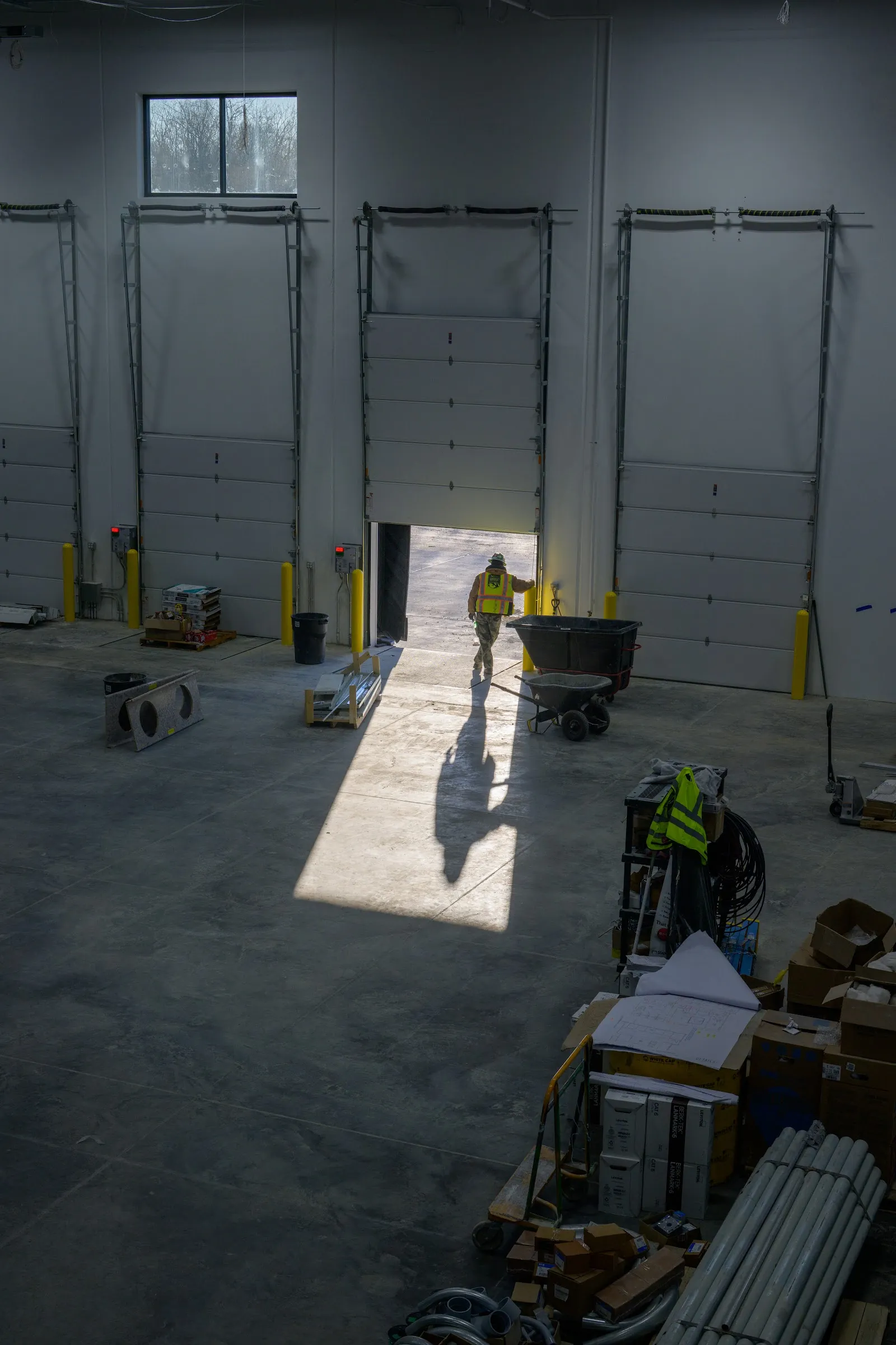 Sunlight falling through an open warehouse door onto the floor