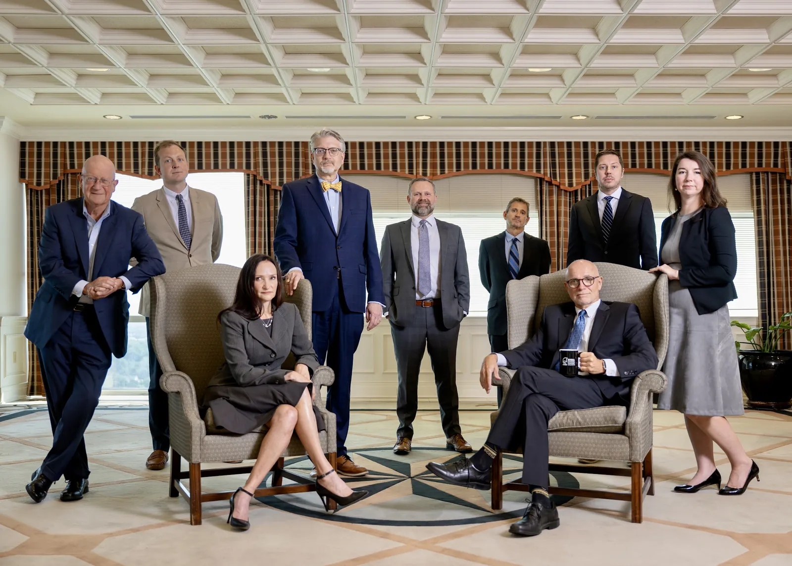 Leadership team posed in a formal office lounge